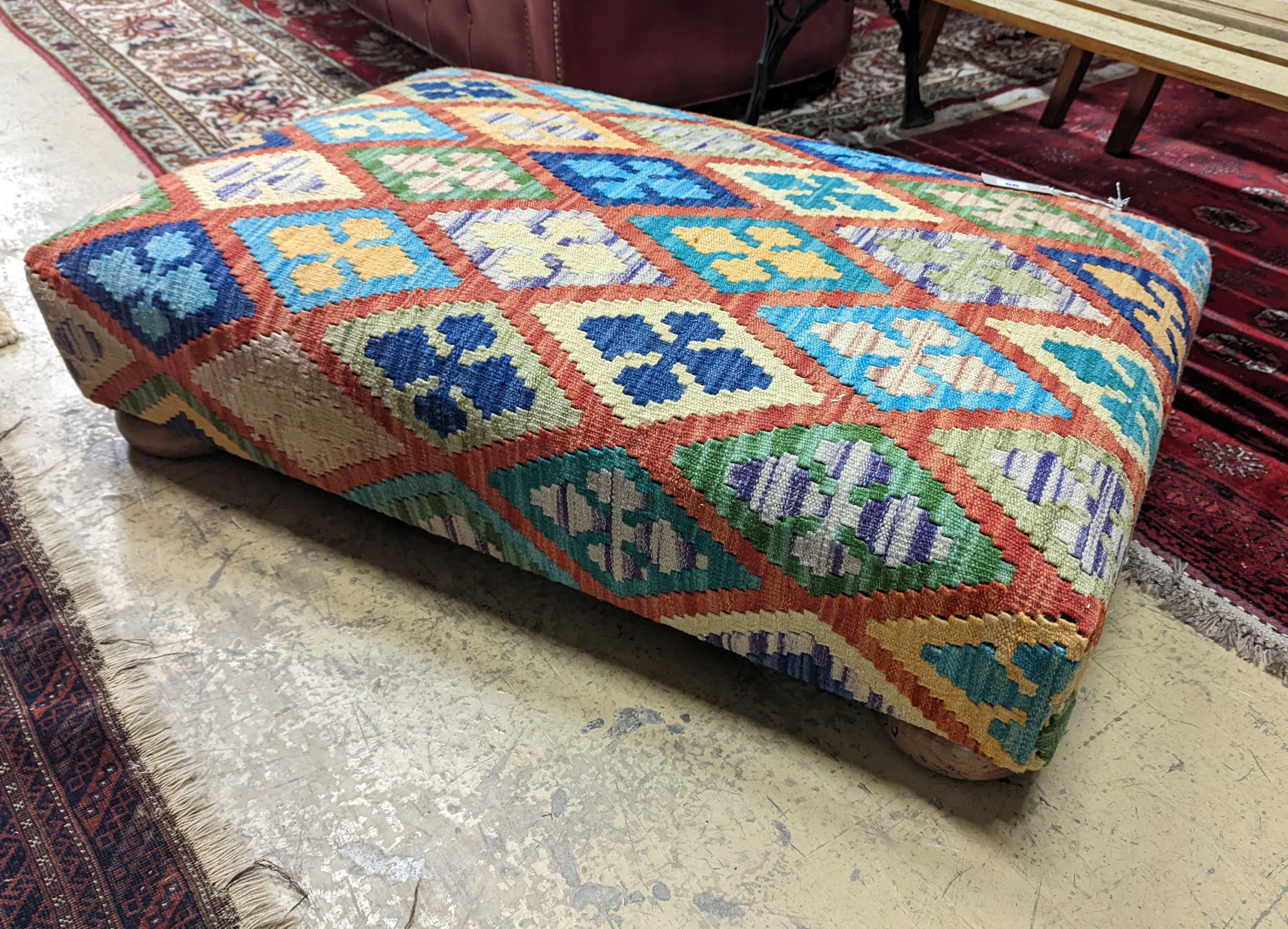 A rectangular Kilim footstool on flat bun feet, length 98cm, depth 62cm, height 22cm